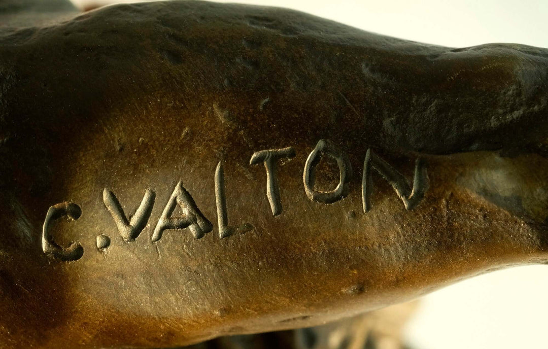 Close-up of the signature 'C. Valton' on a bronze sculpture of a roaring lion, highlighting the artist's craftsmanship.