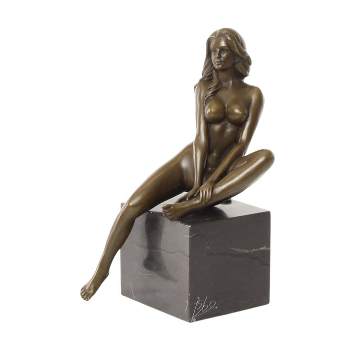 Bronze sculpture of a seated female nude with raised leg on a marble base, showcasing elegant beauty and detail.