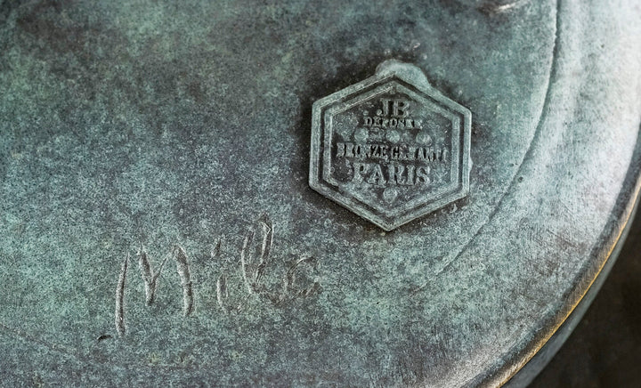 Close-up of a bronze sculpture stamp and signature 'Milo', showcasing quality craftsmanship and authenticity.