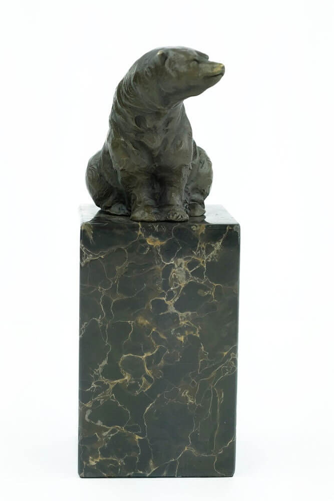 Bronze sculpture of a sitting bear on a flamed marble base, featuring warm brown patina and foundry stamp.