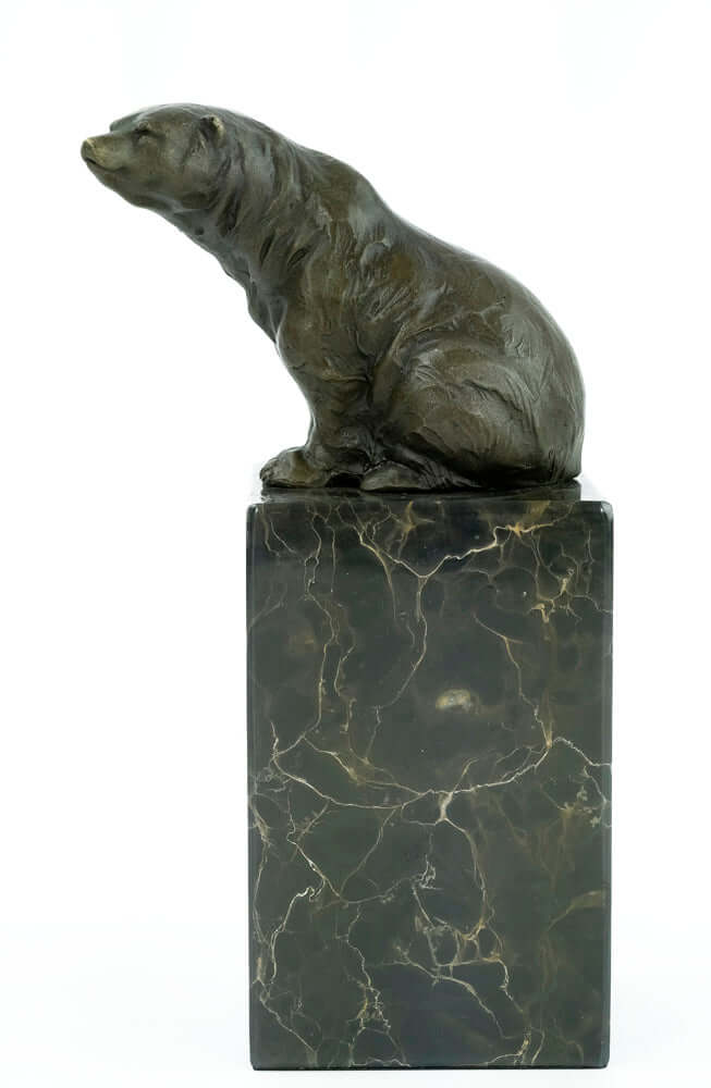 Bronze sculpture of a sitting bear on a flamed marble base, displaying fine craftsmanship and warm patina.