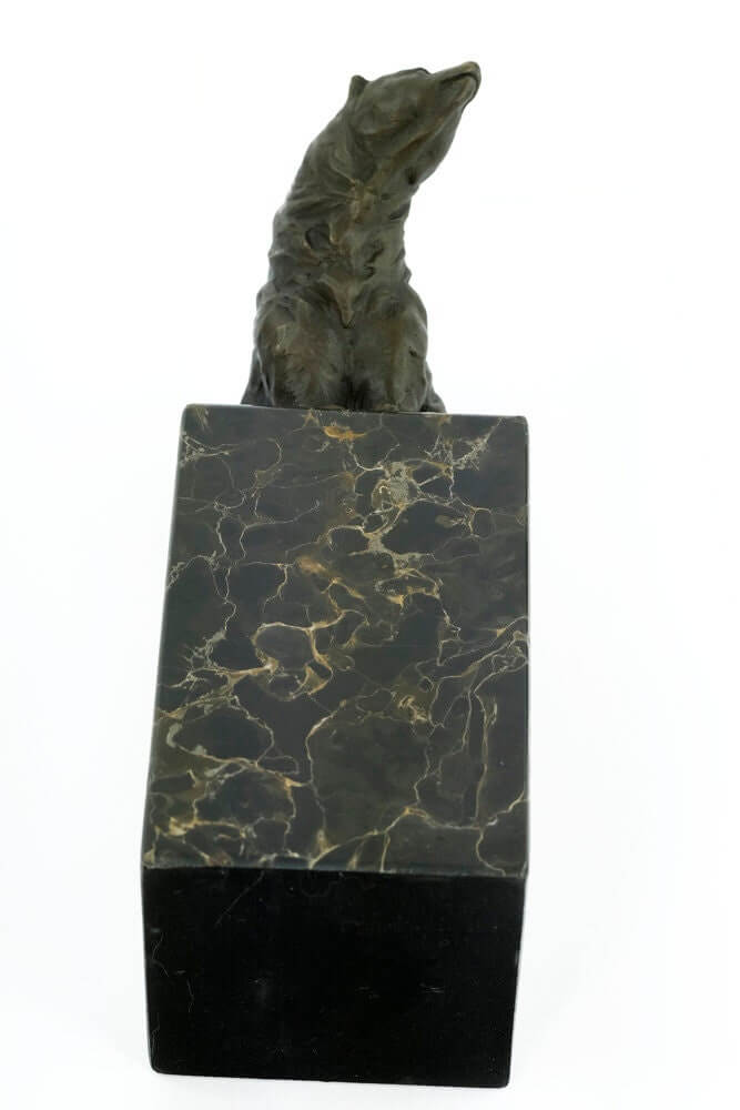 Bronze sculpture of a sitting bear mounted on a flamed marble base, showcasing detailed craftsmanship.
