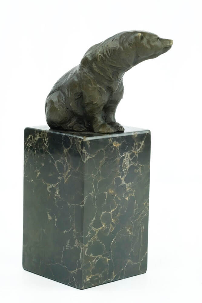 Bronze sculpture of a sitting bear on a flamed marble base, showcasing warm patina and fine craftsmanship.