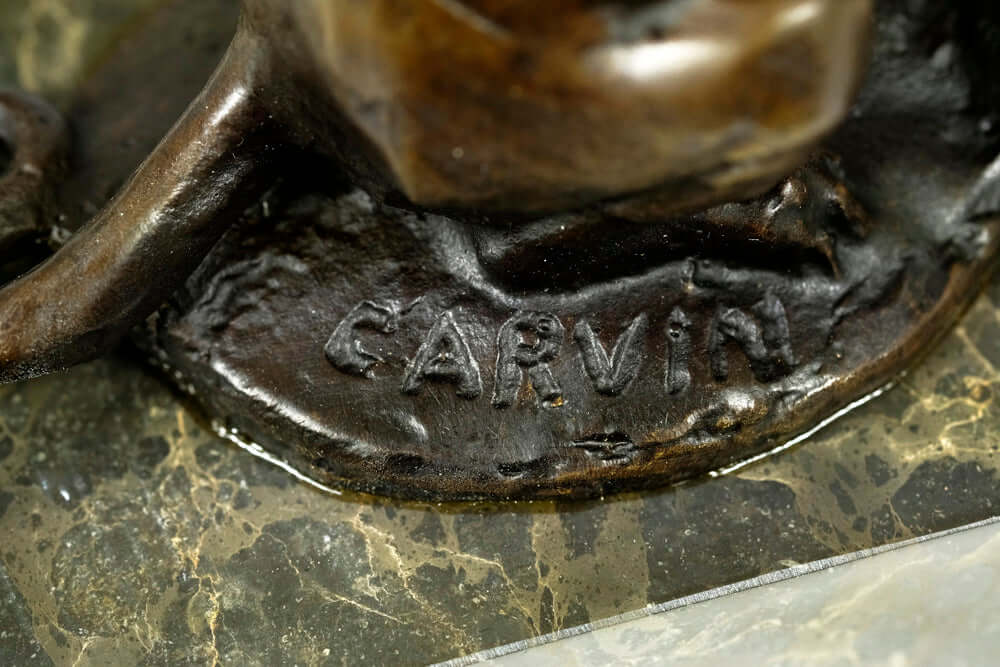 Close-up of the signature 'Carvin' on a bronze panther sculpture, highlighting the artist's craftsmanship.