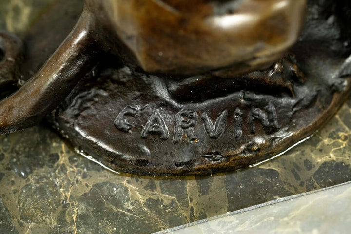 Close-up of the signature 'Carvin' on a bronze panther sculpture, highlighting the artist's craftsmanship.