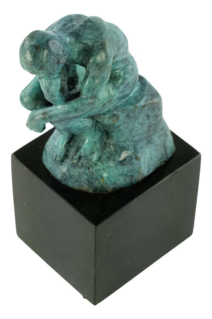 Bronze Thinker sculpture by Rodin in green patina, depicting a nude male thinker on a black marble base.