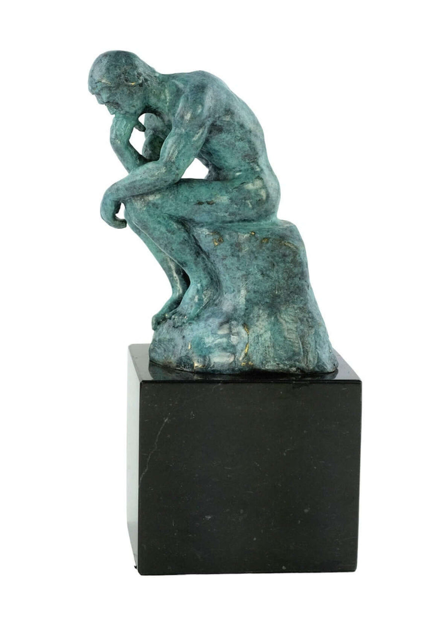Bronze sculpture of Rodin's The Thinker in green patina, depicting a thinking male on a rock, mounted on a marble base.