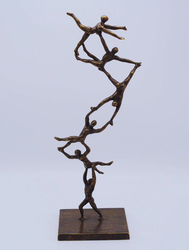 Bronze sculpture 'Together to the Top' depicting abstract figures in a dynamic teamwork climb, symbolizing ambition.