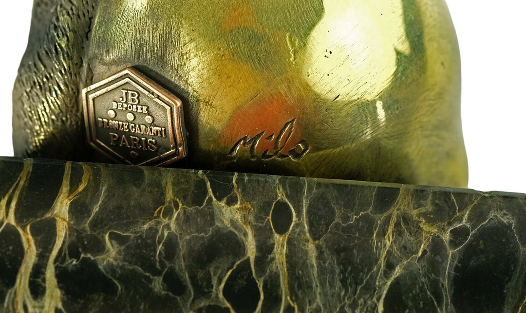 Close-up of the bronze panda sculpture signature and foundry stamp on a flamed marble base.