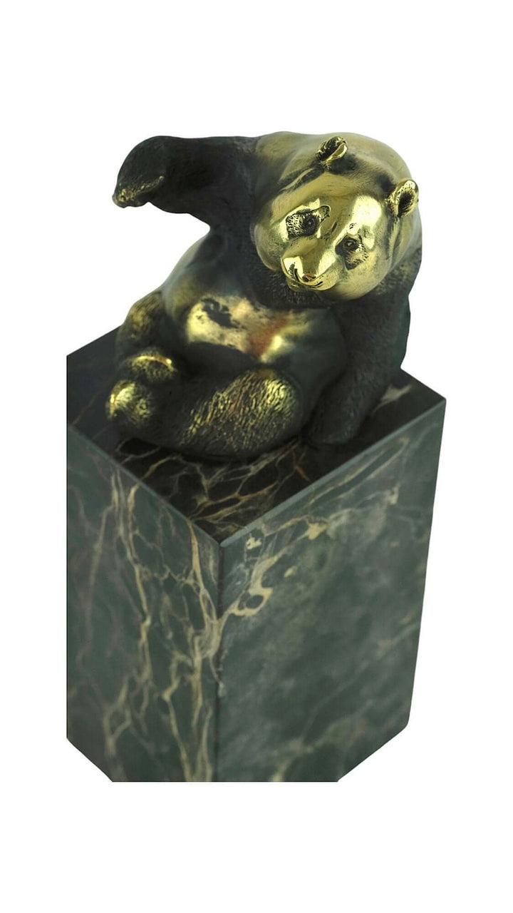 Bronze panda sculpture waving on a flamed marble column, showcasing detailed craftsmanship and joyfulness.