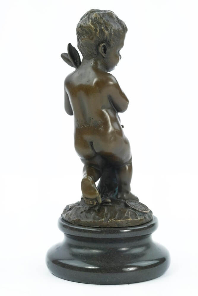 Bronze sculpture of a young boy holding a rabbit, mounted on a round marble base, 15 cm tall.