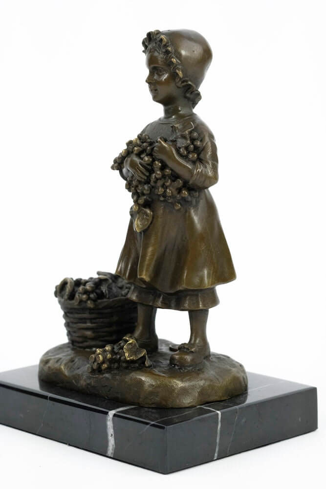 Bronze sculpture of a young girl harvesting grapes, beautifully detailed and mounted on a marble base.