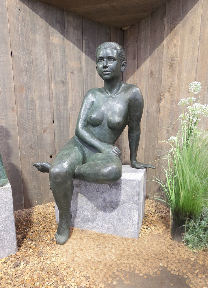Bronze sculpture of a sitting female nude