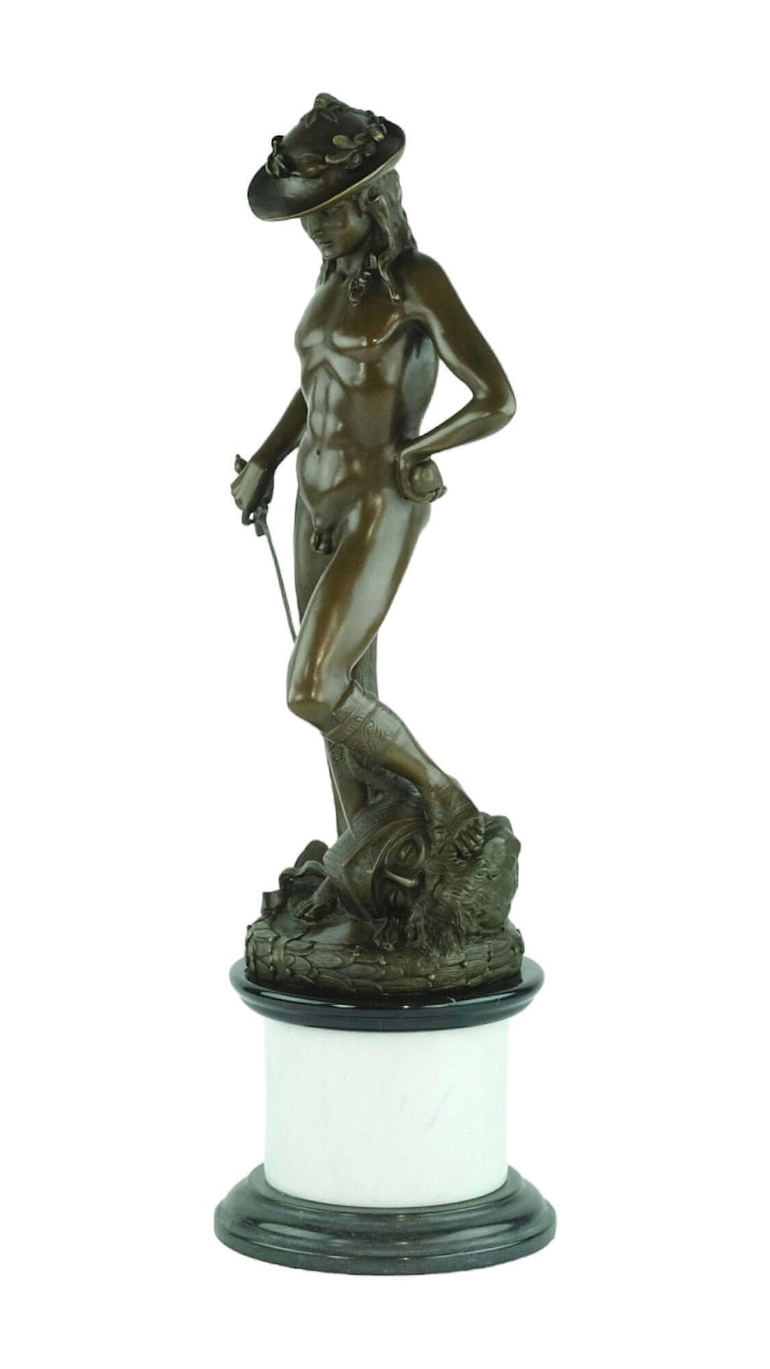 Bronze sculpture of David standing triumphantly on Goliath's head, intricately detailed and mounted on marble base.