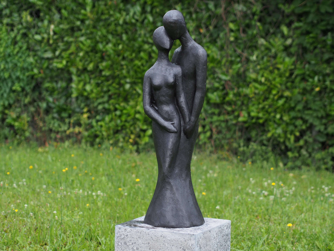 Large bronze sculpture of a loving couple in an intimate pose, perfect for outdoor display, with a dark patina finish.