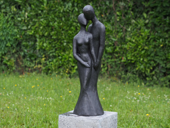 Large bronze sculpture of a loving couple in an intimate pose, perfect for outdoor display, with a dark patina finish.