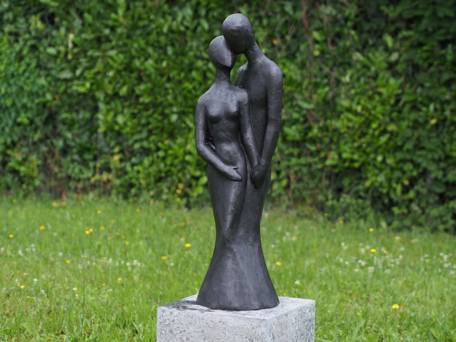 Large bronze sculpture of a loving couple in an intimate pose, perfect for outdoor display, with a dark patina finish.