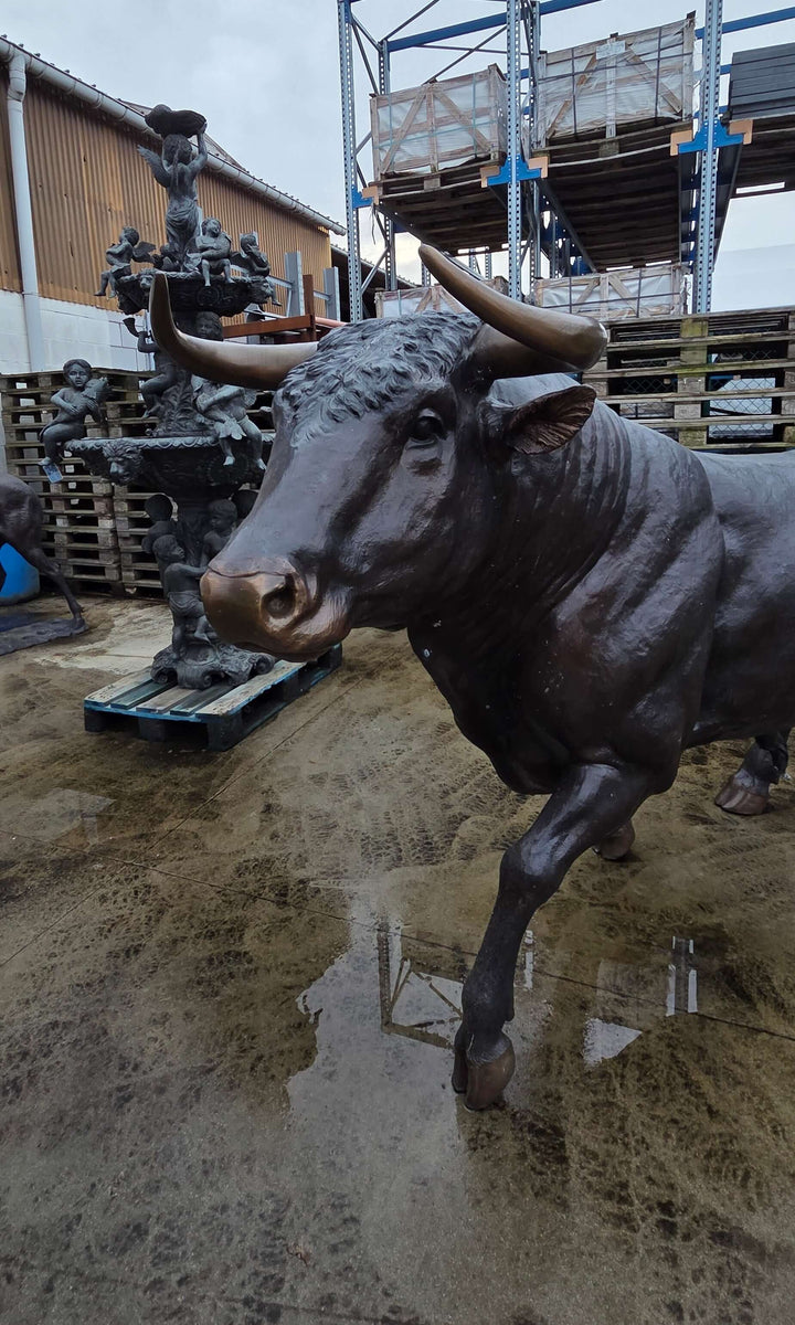 Lifesize bronze bull sculpture showcasing intricate details in a realistic design, perfect for outdoor decor.