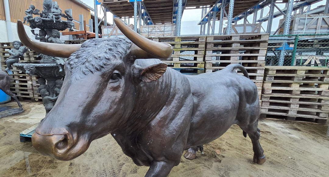 Lifesize bronze bull sculpture with detailed features, perfect for outdoor display and lasting durability.