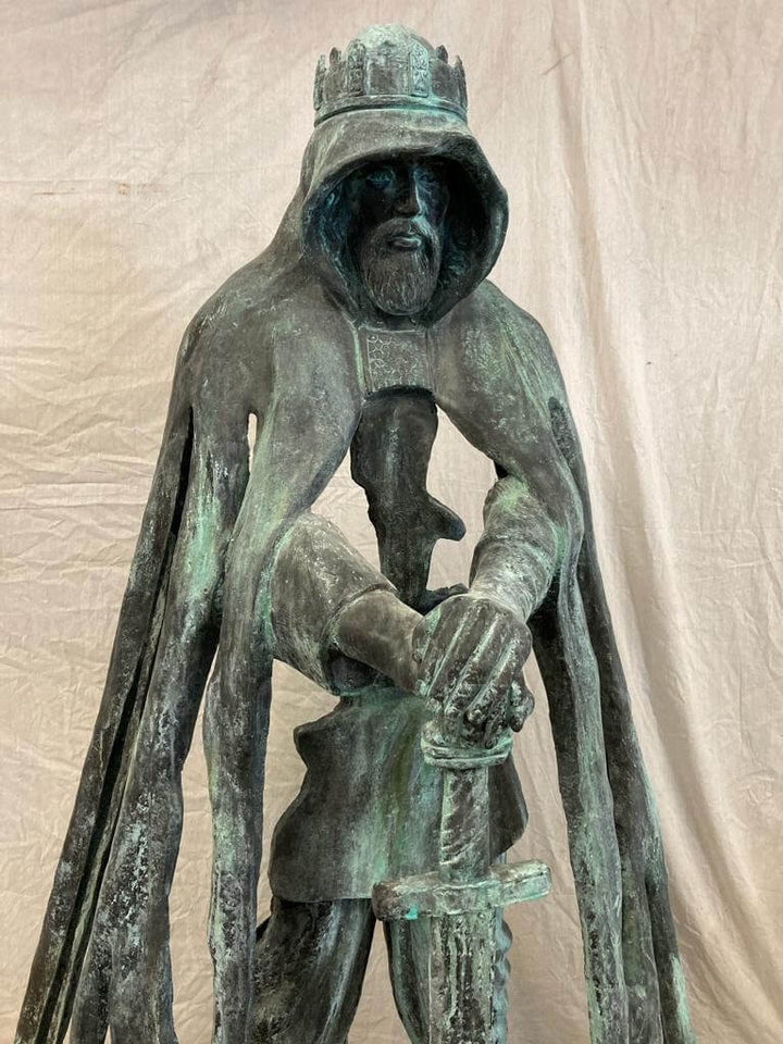 Lifesize bronze sculpture of King Arthur with sword, by Rubin Eynon, at Tintagel Castle, Cornwall, UK.