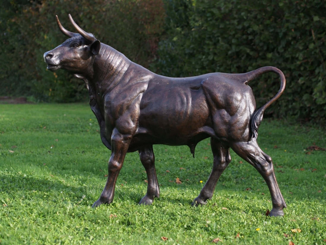 Lifesize bronze sculpture of a standing bull with detailed craftsmanship and brown patina finish.
