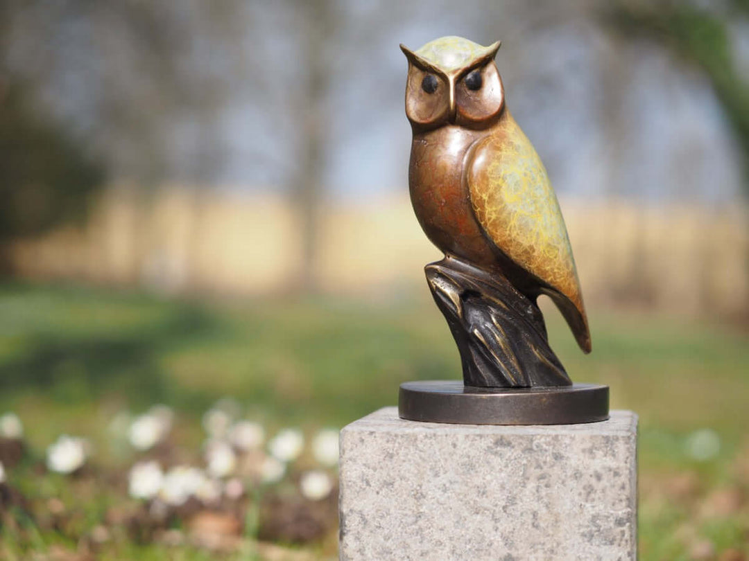 Modern bronze owl sculpture with unique patina, perched on a branch-like base, ideal for indoor or outdoor display.