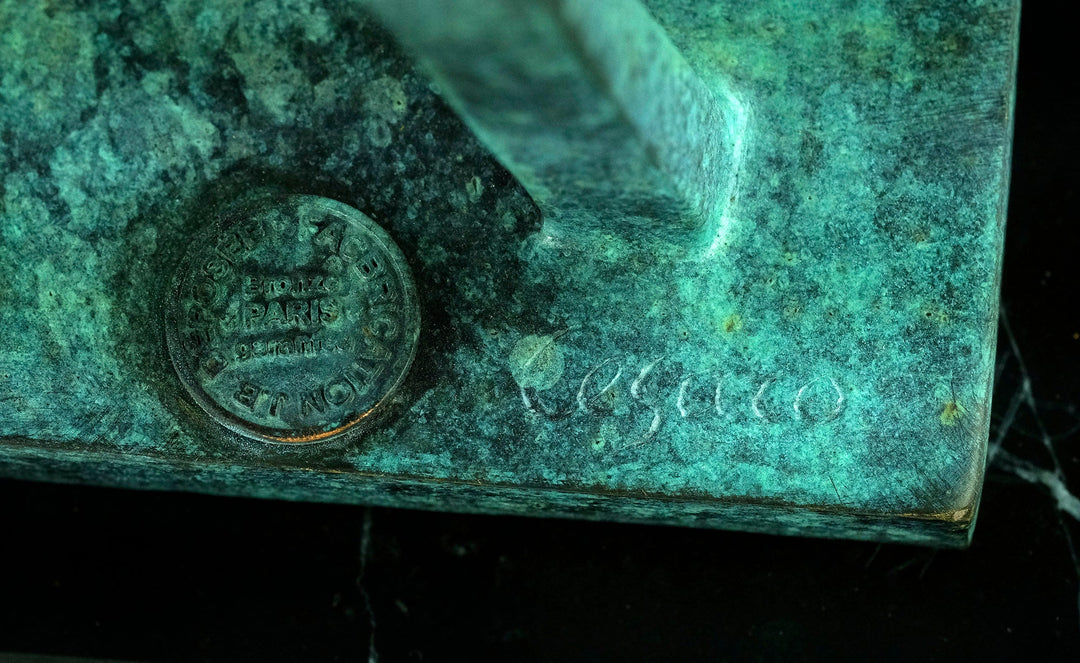 Close-up of bronze sculpture base showing the signature 'Césaro' and a circular stamp with details.