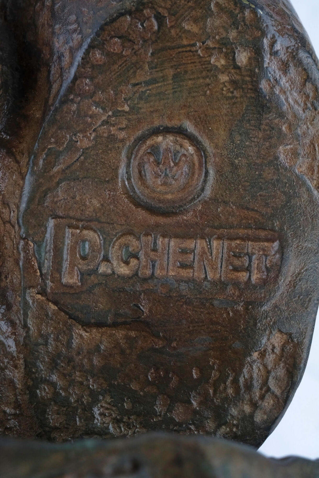 Close-up of Pierre Chenet signature and foundry stamp on a bronze sculpture's base, showcasing authenticity and craftsmanship.