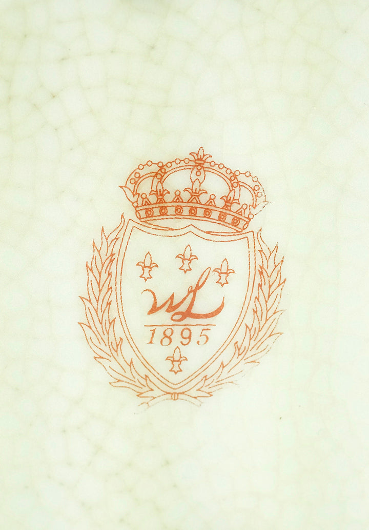 Porcelain maker's mark featuring a crown and the year 1895, showcasing fine craftsmanship and heritage.